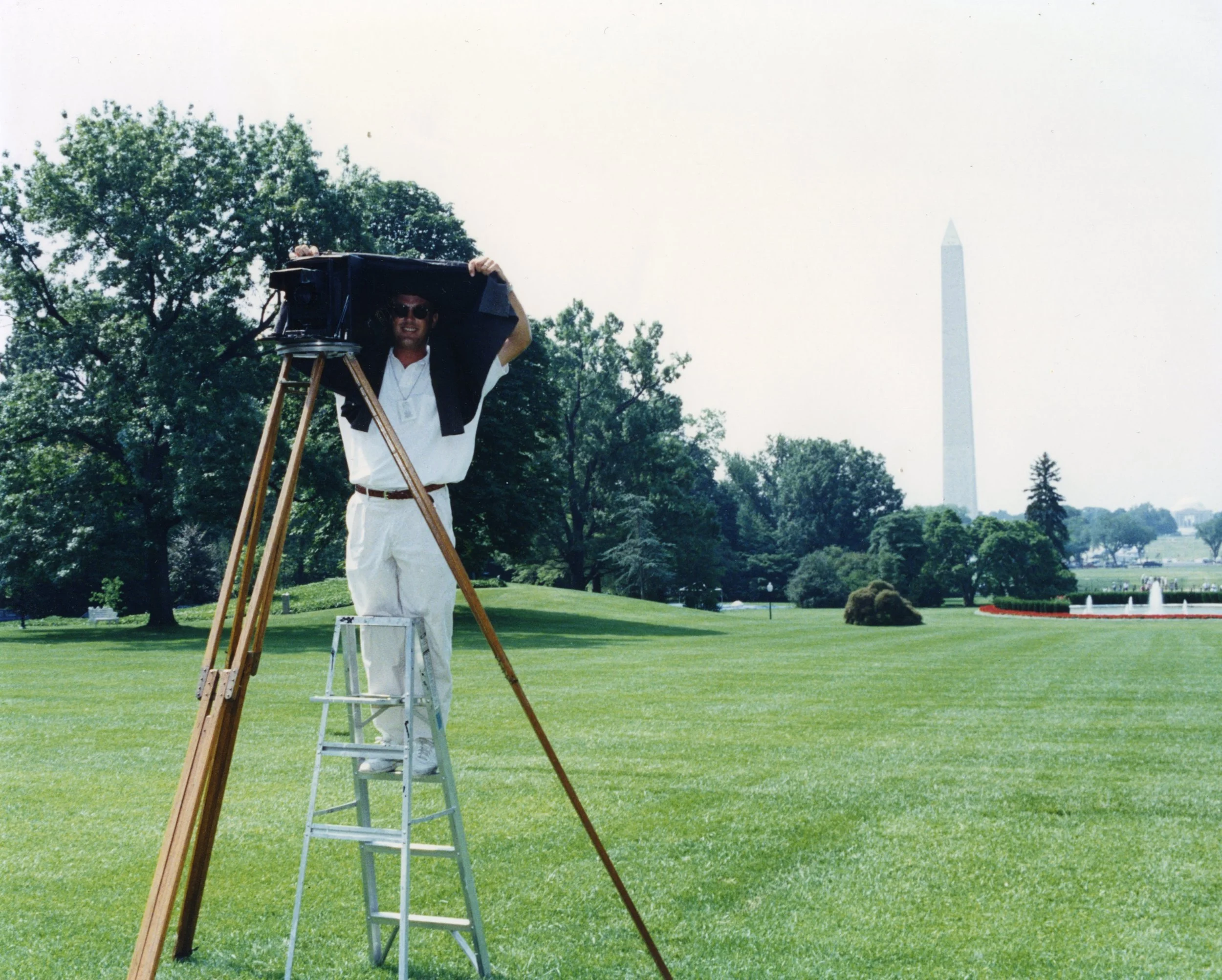 Large group panoramic portrait at the Washington Monument with American flags, Washington, DC national mall. Central Photo Company