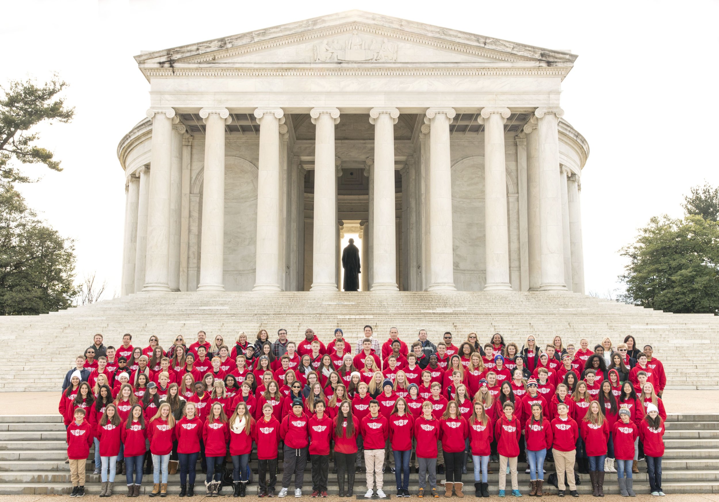 Family reunion group portrait at the Thomas Jefferson Memorial with Tidal Basin and cherry blossoms, Washington, DC. Central Photo Company