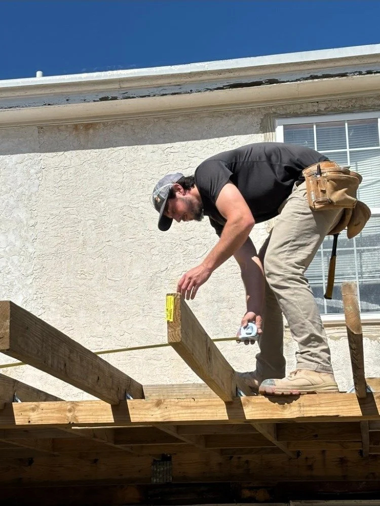 Craftsman on scaffolding installing roof framing for a home addition in Bucks County PA