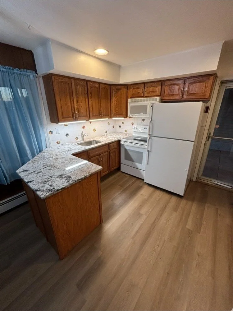 Kitchen remodel with new granite countertops and luxury vinyl flooring in Delaware County PA