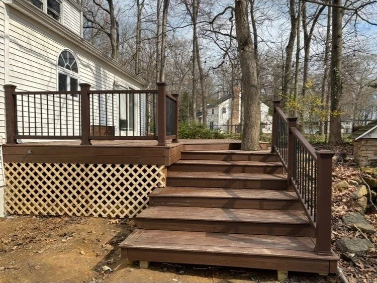 Custom deck with composite stairs and black metal railing in Montgomery County PA