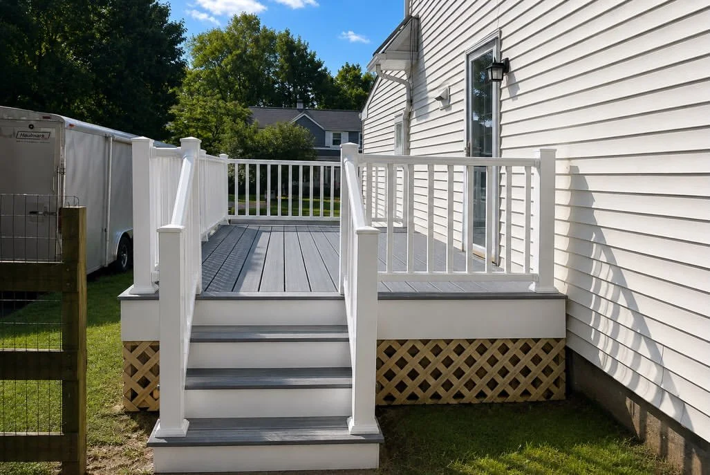 Completed gray composite deck with white stairs and railing