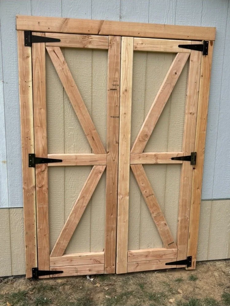 Handcrafted cedar barn doors with black iron hardware for custom outbuilding in Montgomery County PA