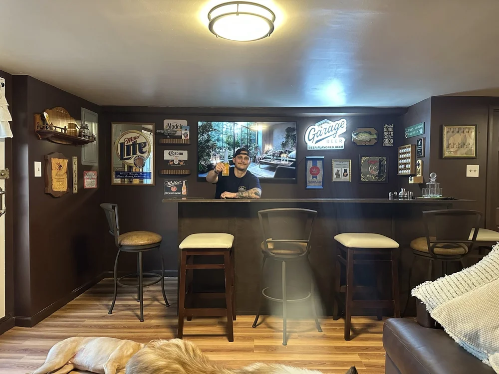 Homeowner at the finished basement bar built by JMJ Home Remodeling