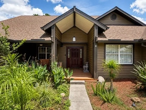 Front entry with contrasting trim and landscaping
