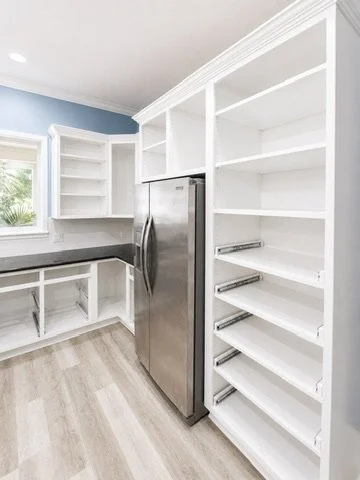 During refinishing — pantry doors removed and shelving exposed