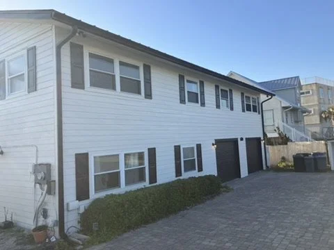 Light siding and windows along the side elevation