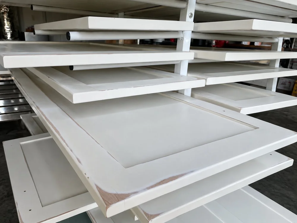 White cabinet doors arranged on a drying rack
