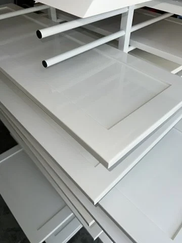 Cabinet doors laid out on finishing racks