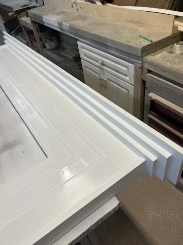 White painted trim prepared for installation
