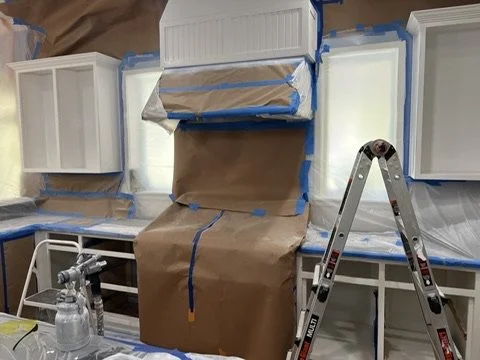 Kitchen appliances and counters masked during cabinet preparation