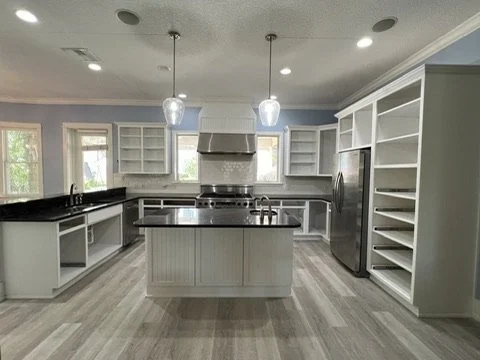 Kitchen cabinets with doors removed during refinishing