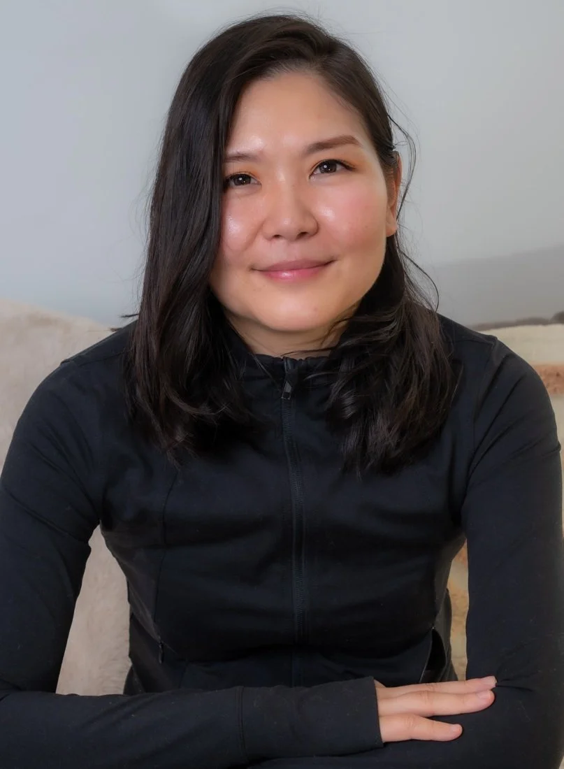 Relaxed seated portrait of a woman in soft light