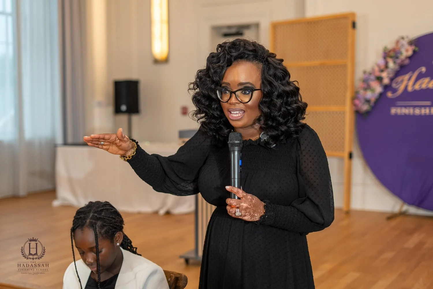 A facilitator speaking into a microphone during a session