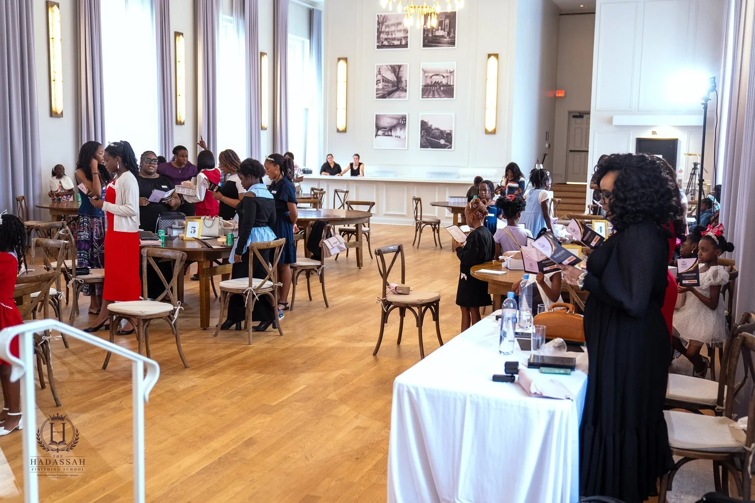 Participants and facilitators gathered around tables in the event room