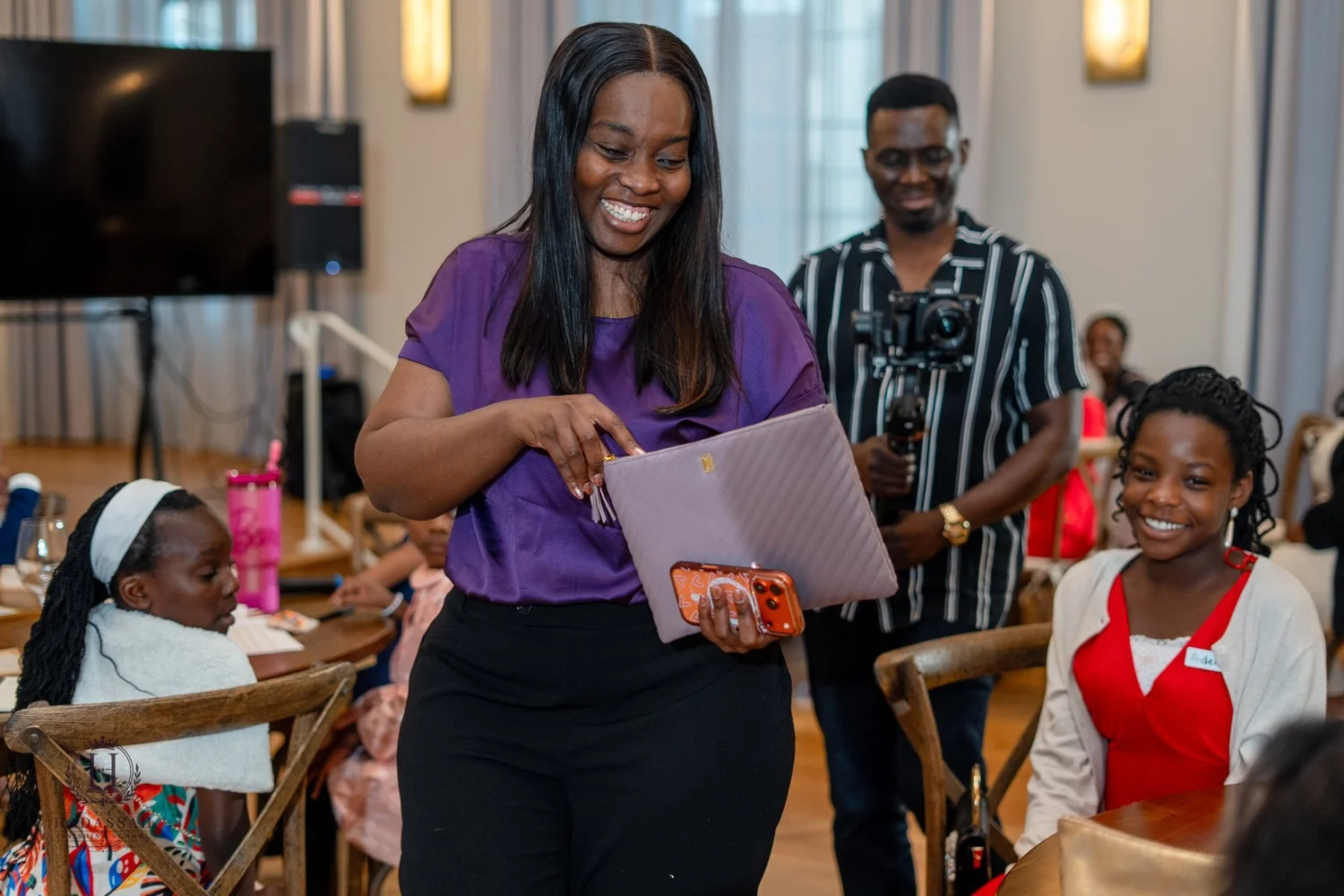 A smiling facilitator sharing a moment with seated participants