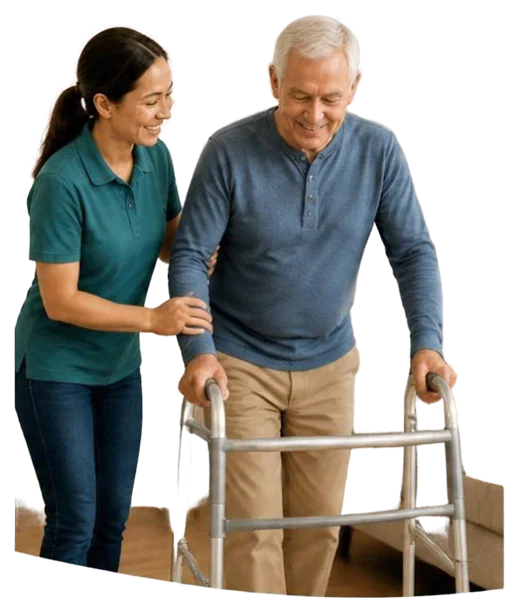 An older adult using a walker with support from a caregiver