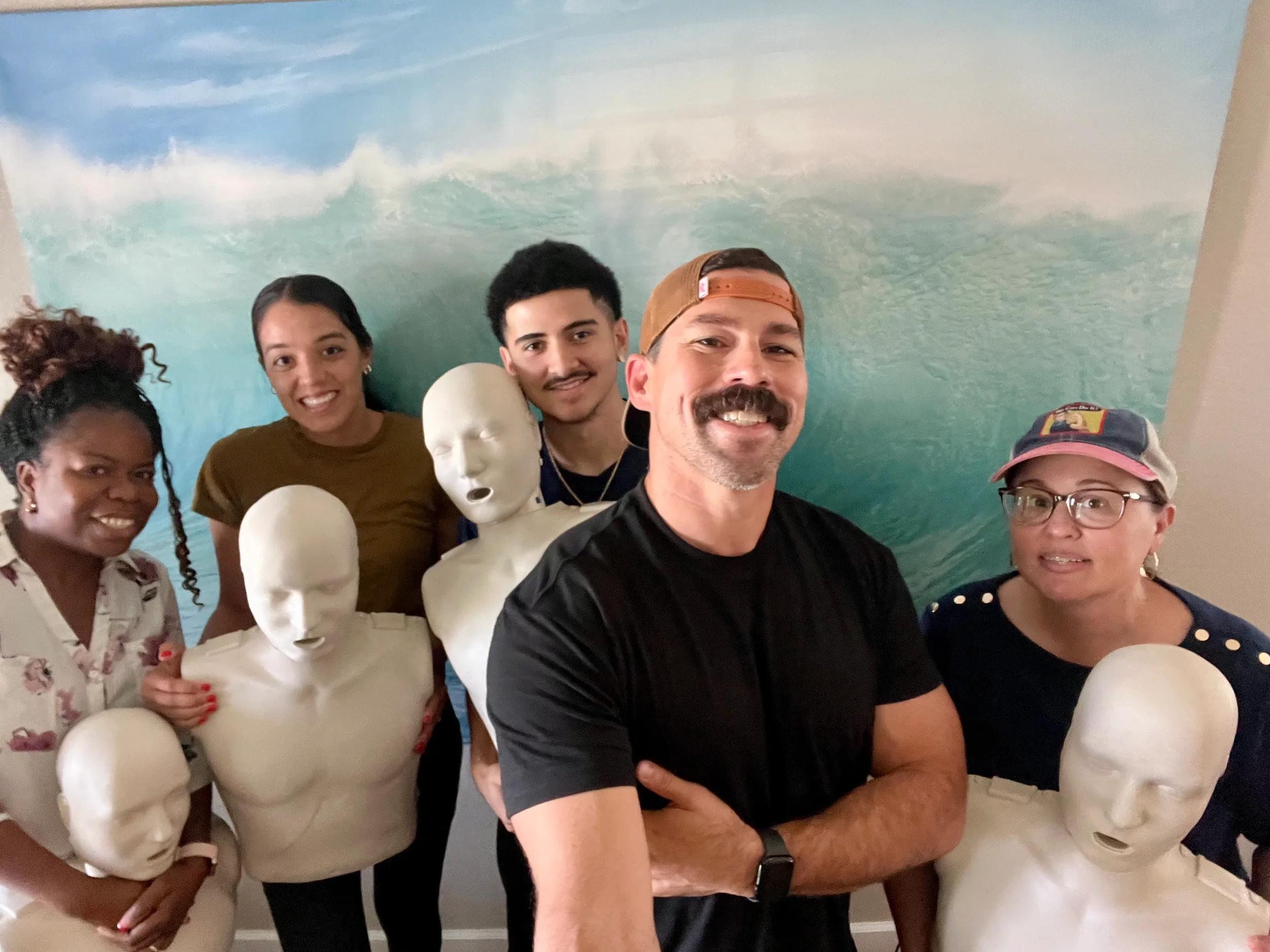 Small group CPR training session with Gabe Santa Cruz