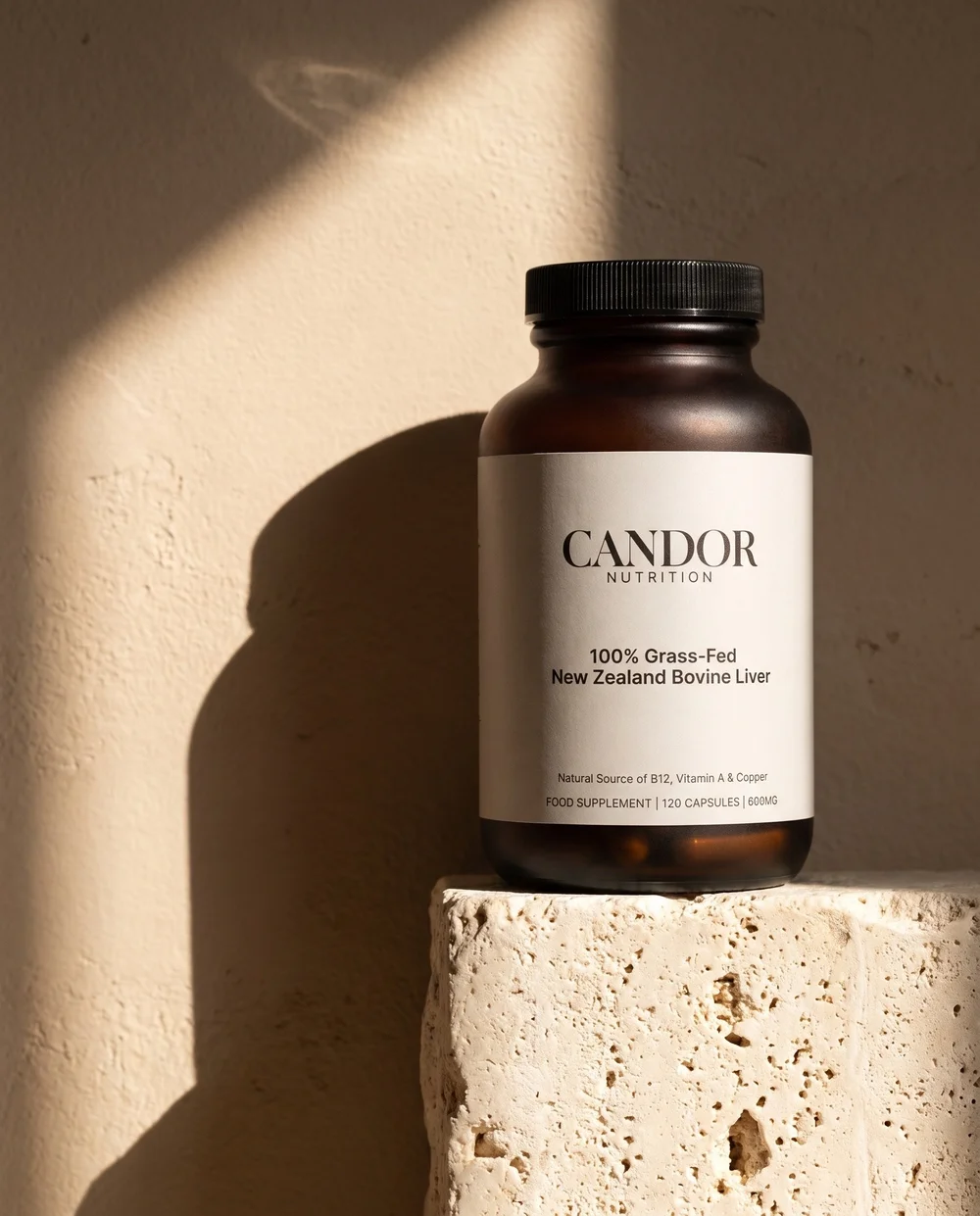 Candor Nutrition jar on a sunlit stone plinth