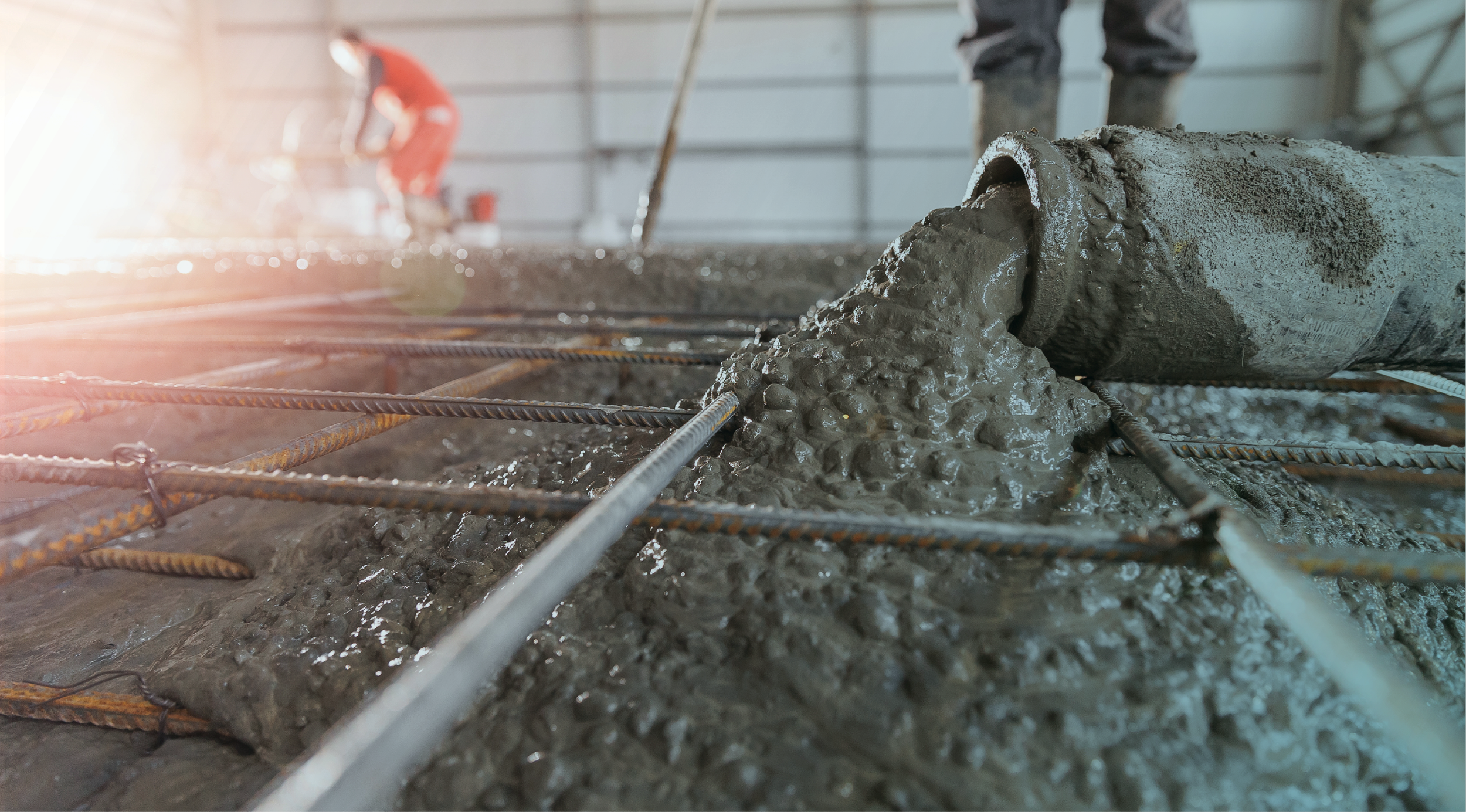 Concrete being poured over rebar at a job site