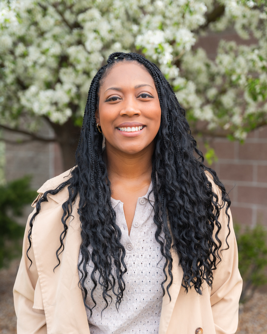 Jasmine Wilder smiling outdoors in a professional portrait.