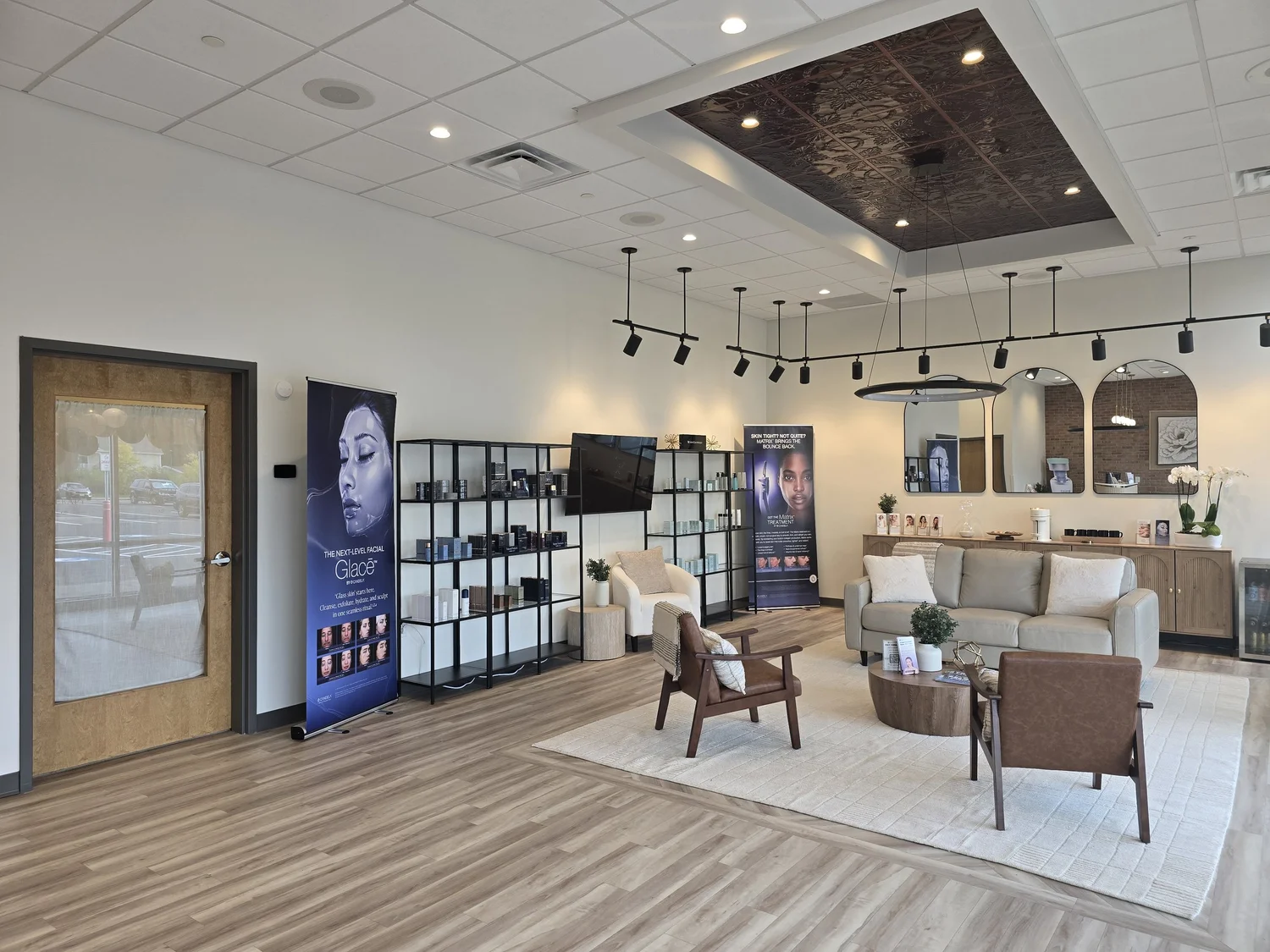 SkanWell reception lounge with comfortable seating, skincare displays and warm lighting