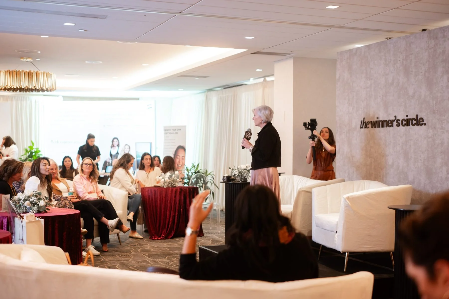 Christina Langdon addressing a full room at a Winner's Circle event