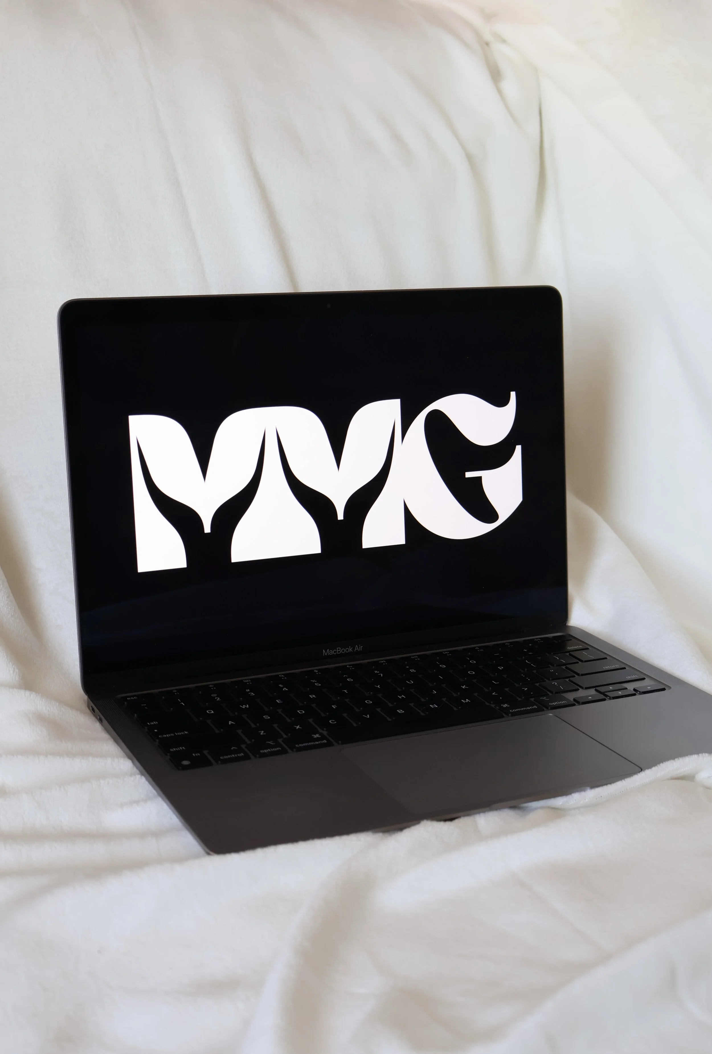 McGrann Marketing Group brand mark displayed on a laptop screen