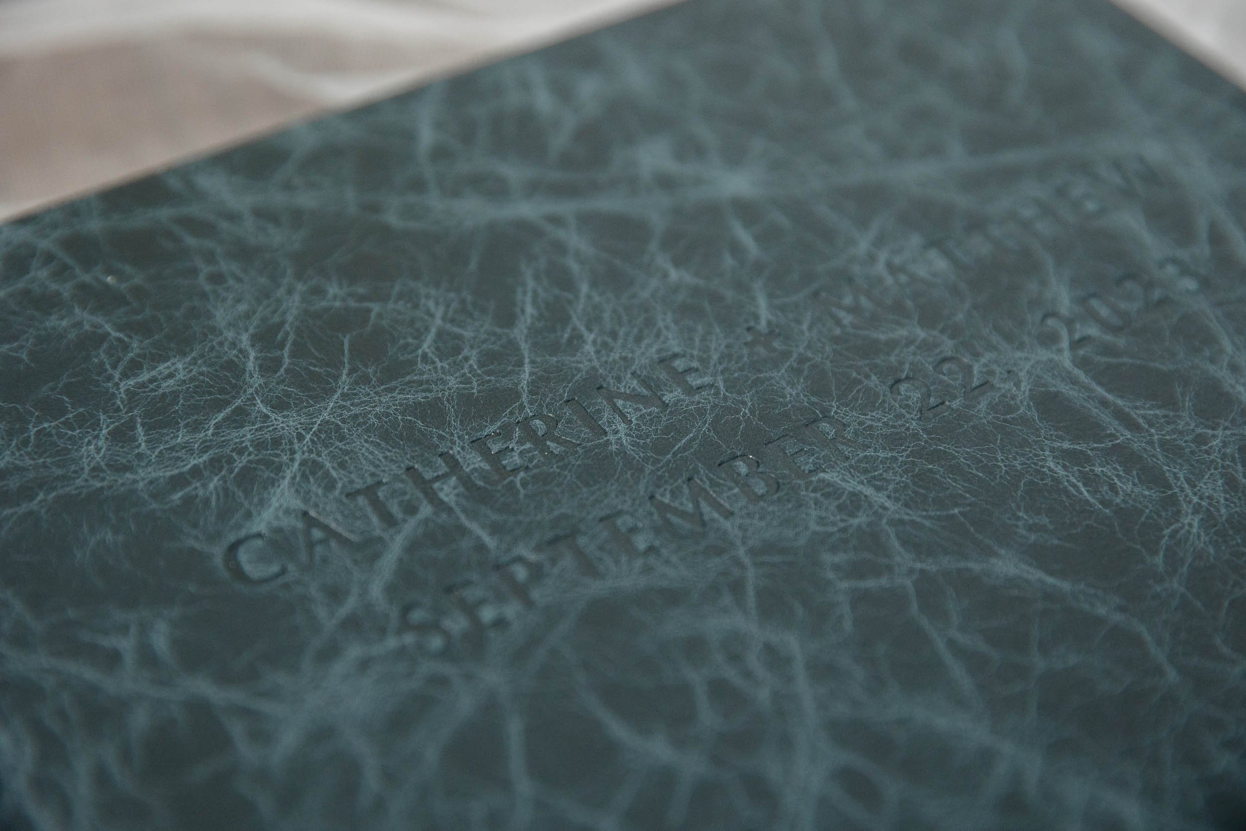 Debossed names and wedding date on a leather album cover