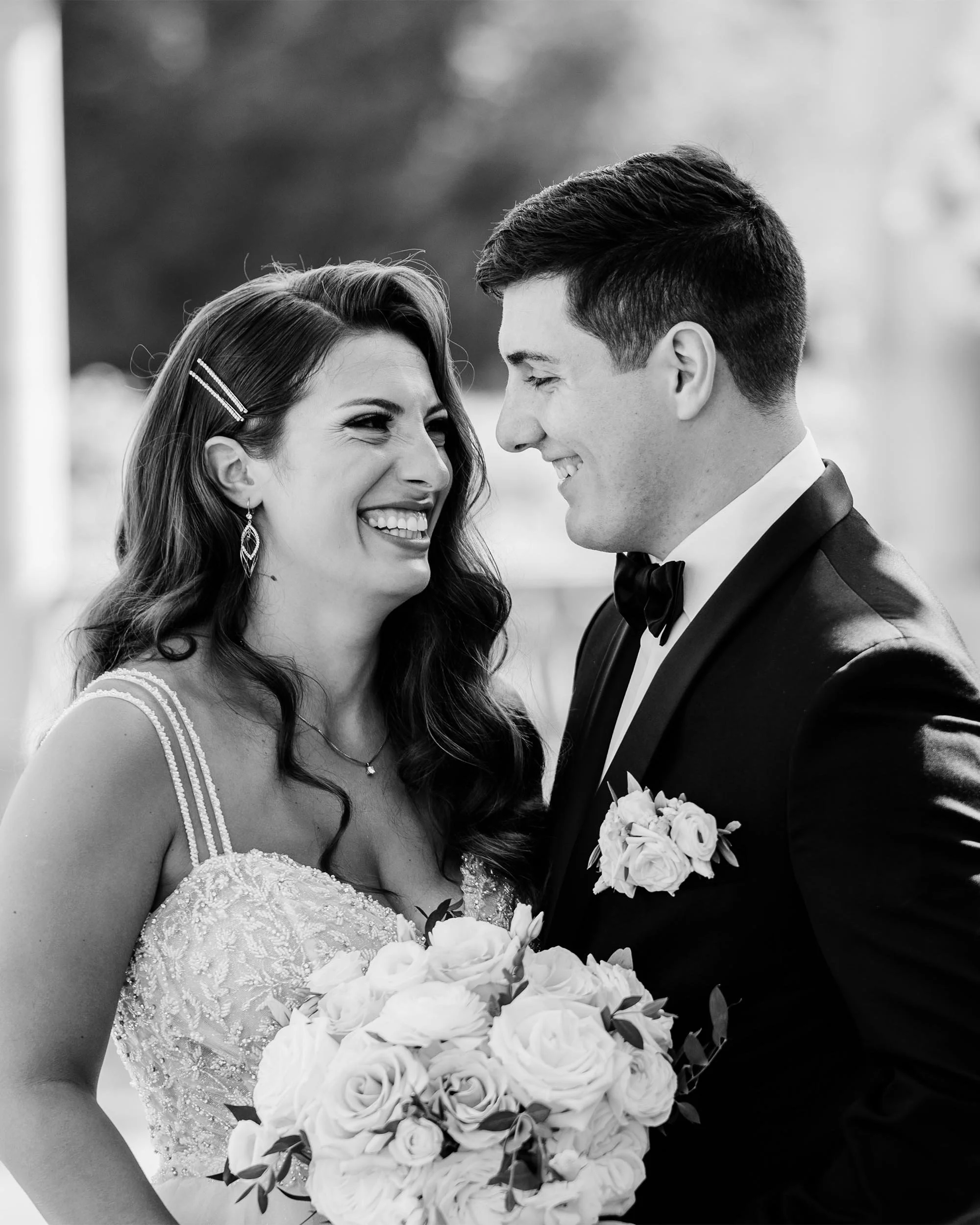 A couple laughing together during their wedding photos