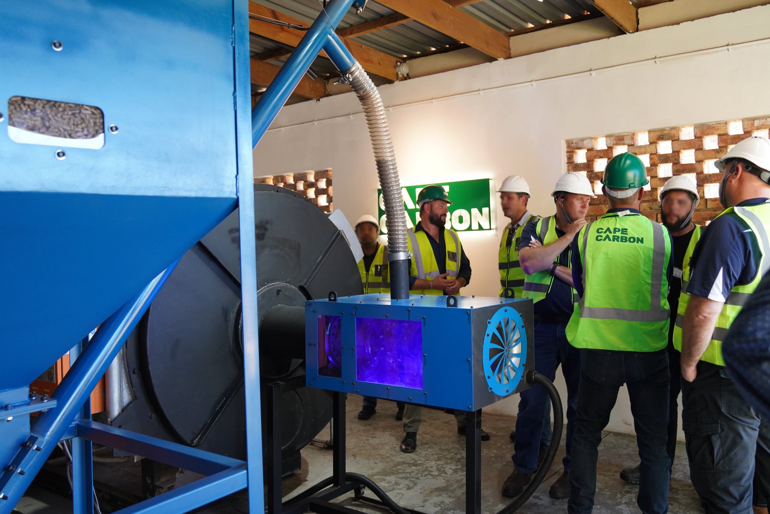 Guests gathered around the converted boiler in Cape Carbon's boiler room
