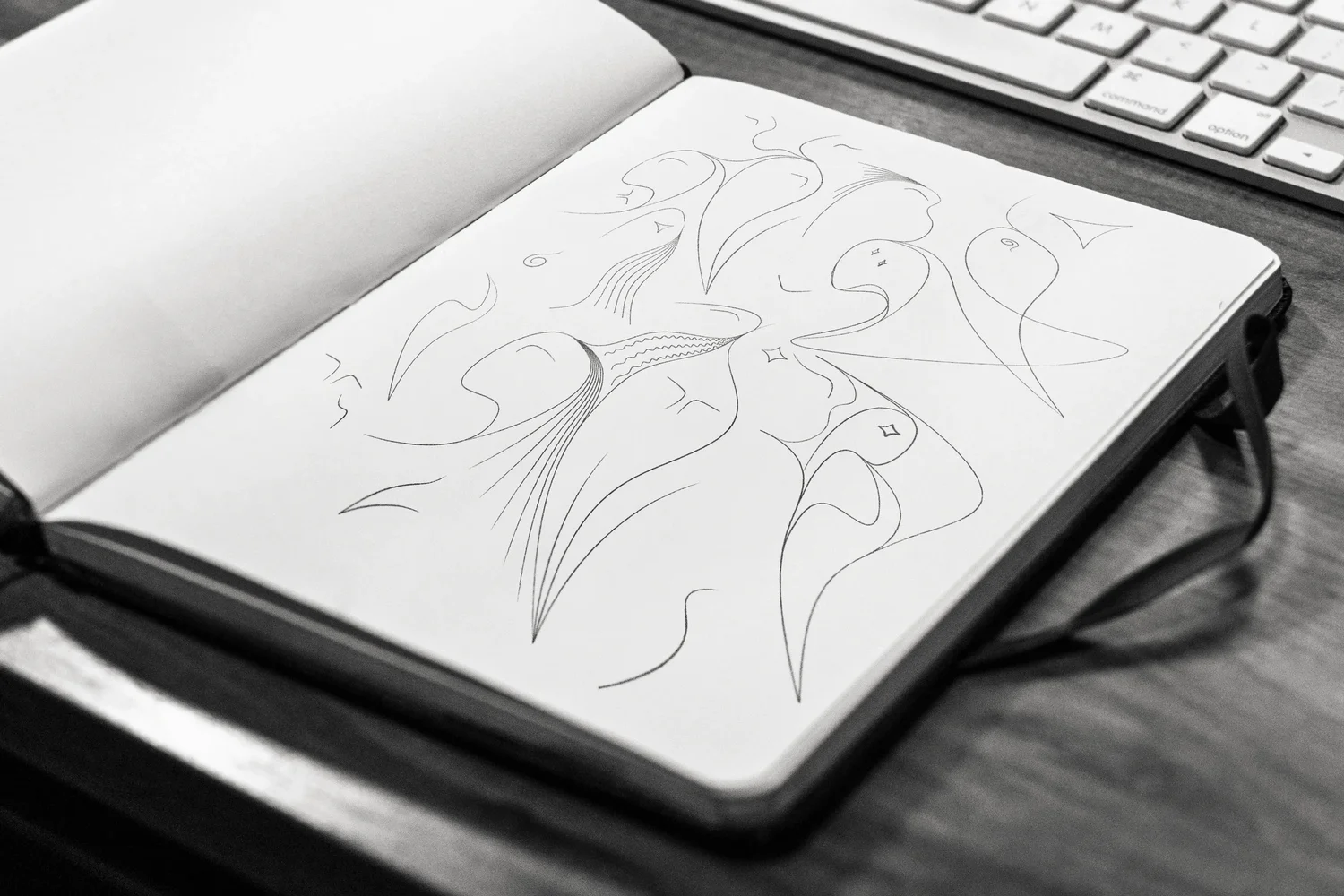 A sketchbook open on a table, with pencil studies for the La Diffrance figures