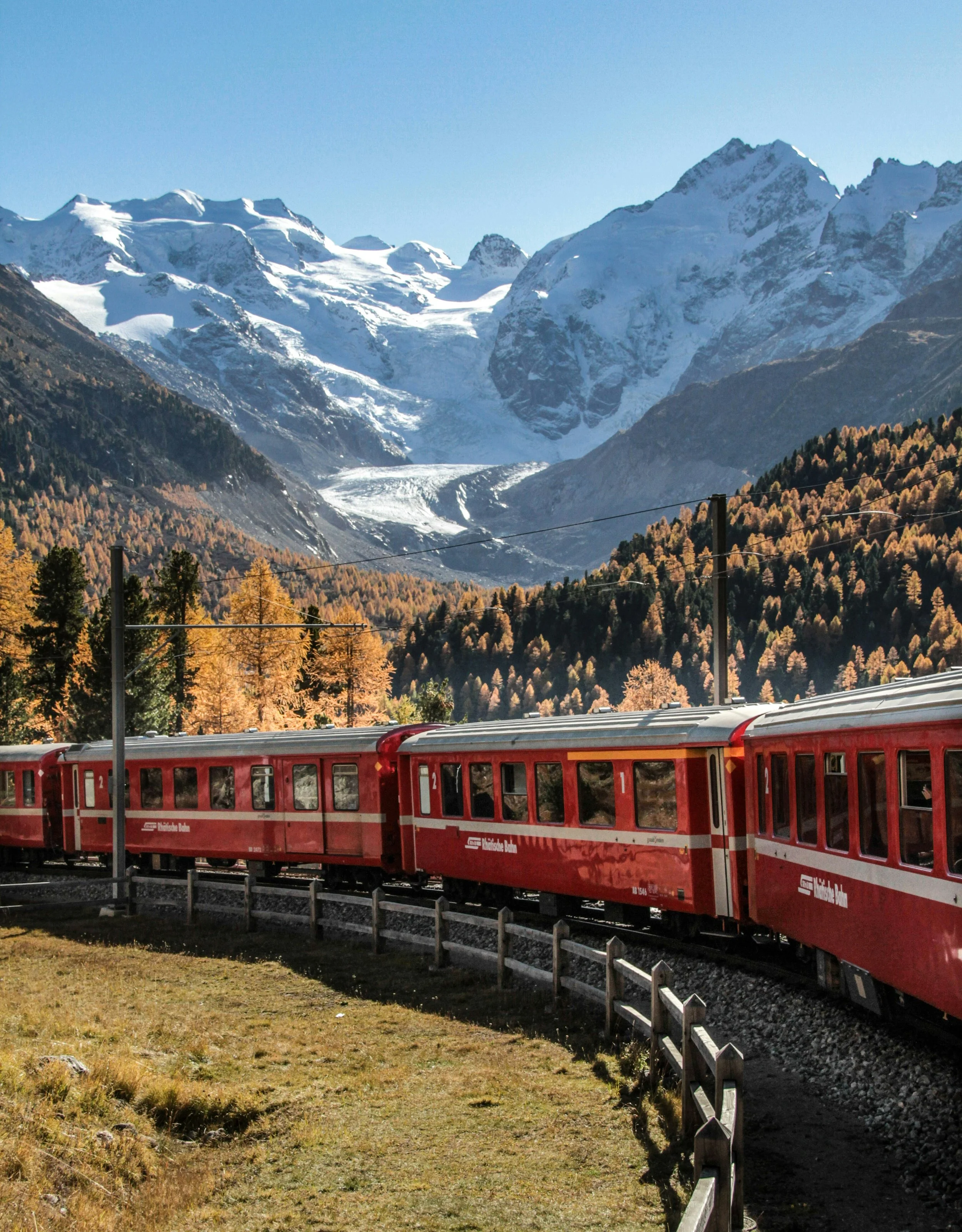 Scenic alpine or coastal rail landscape seen from a train window