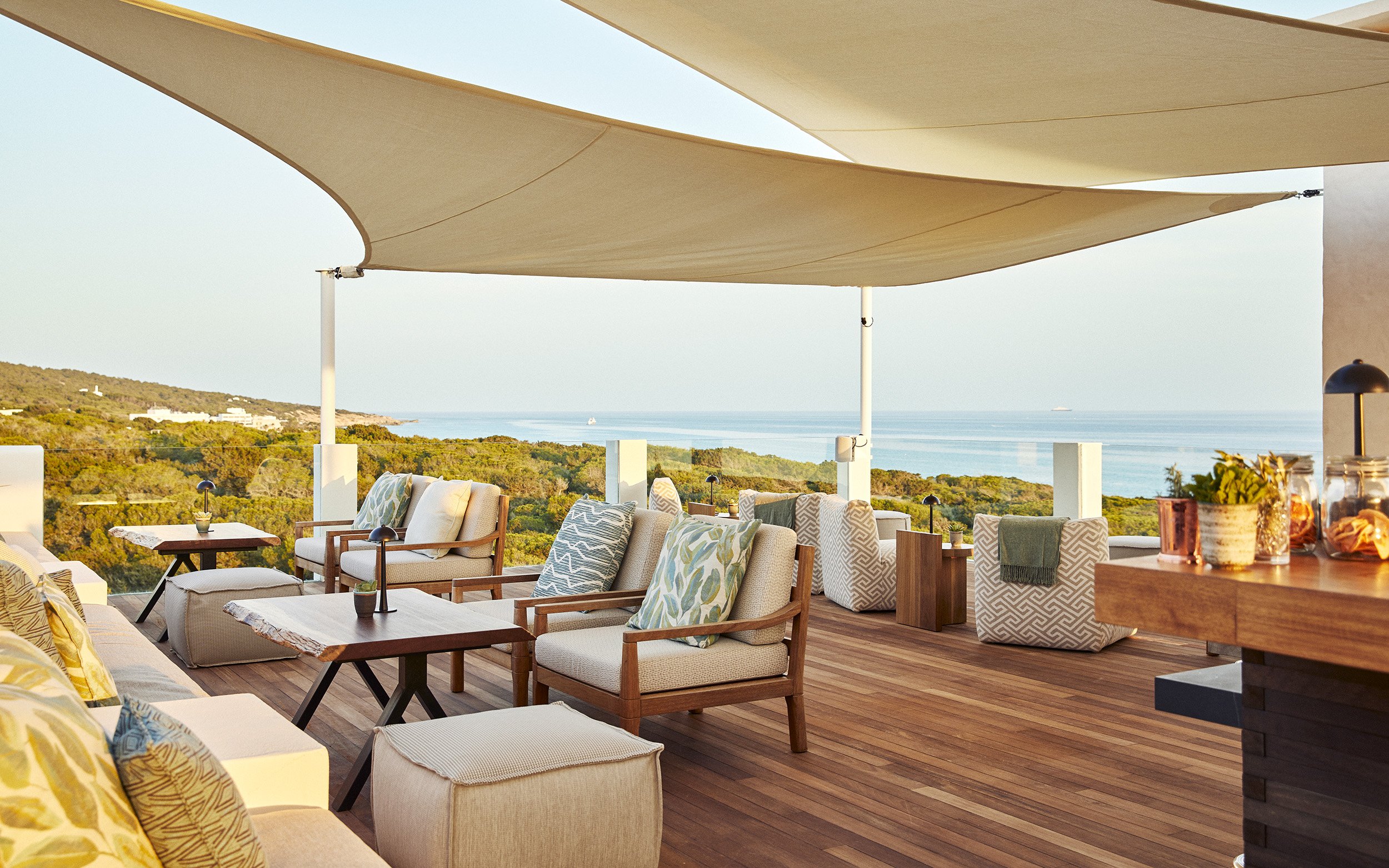 Rooftop bar above the pine canopy at Teranka, Formentera, set for evening cocktails