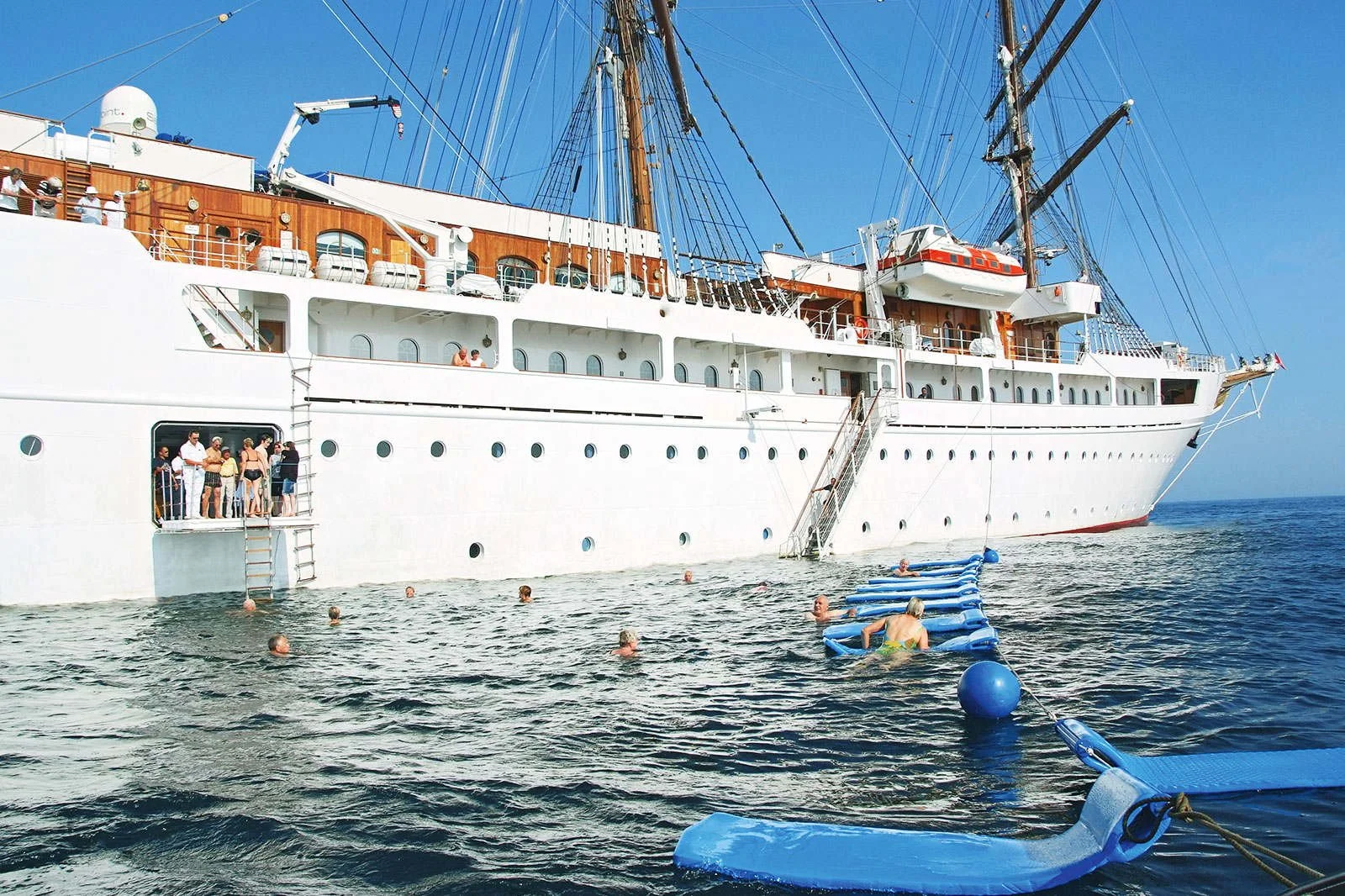 Guests swimming from the watersports platform of Sea Cloud II in the British Virgin Islands