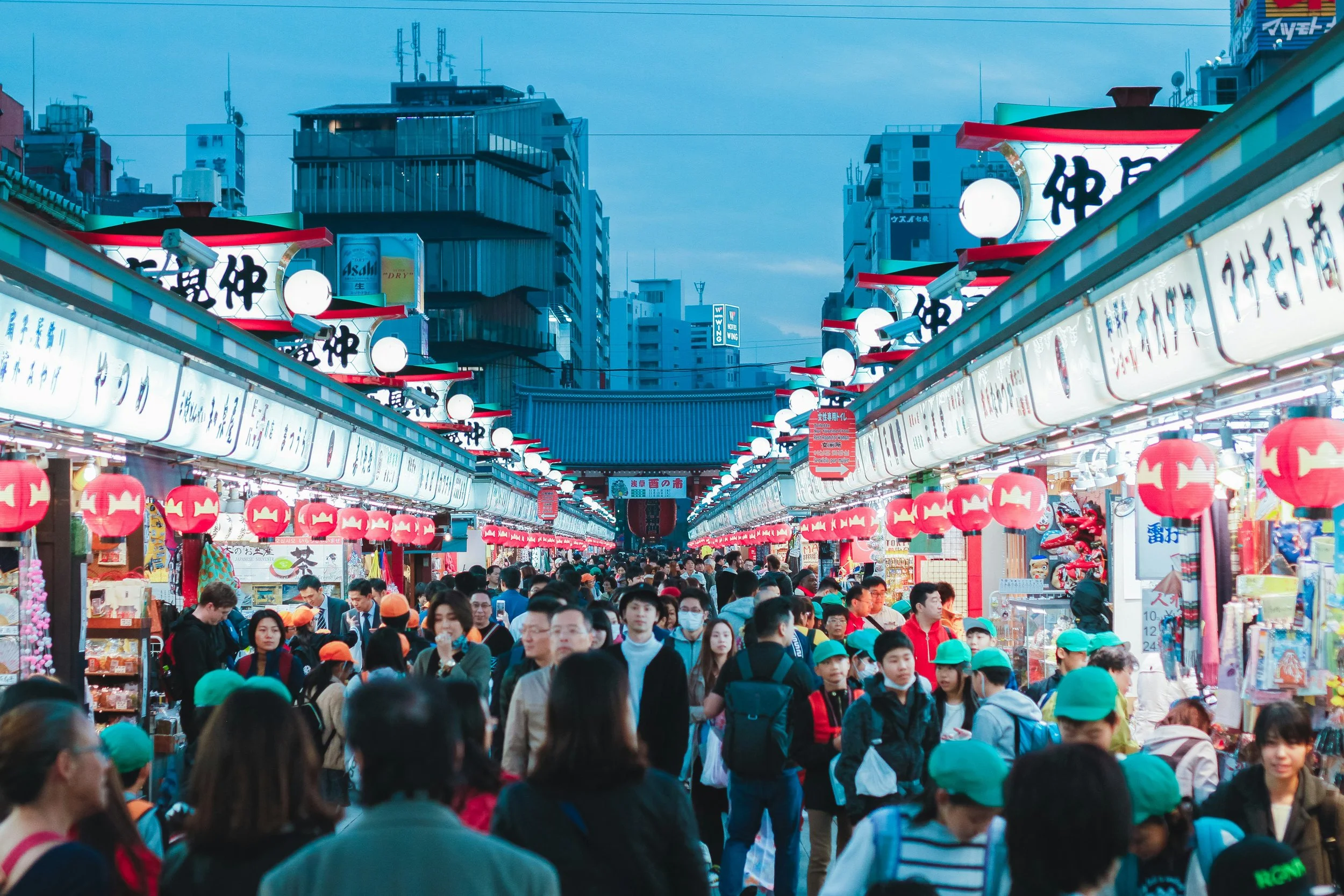 Covered shopping arcade in Koenji, Tokyo, neon signs and
         independent boutiques, afternoon light