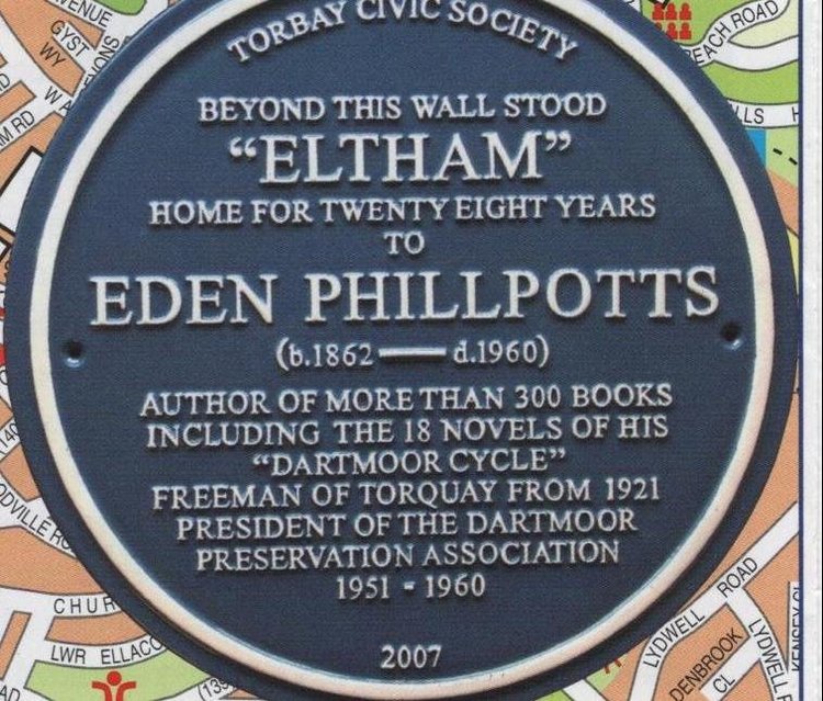 Blue plaque reading Torbay Civic Society, beyond this wall stood Eltham, home for twenty eight years to Eden Phillpotts, born 1862 died 1960, author of more than 300 books including the 18 novels of his Dartmoor Cycle, Freeman of Torquay from 1921, President of the Dartmoor Preservation Association 1951 to 1960, 2007