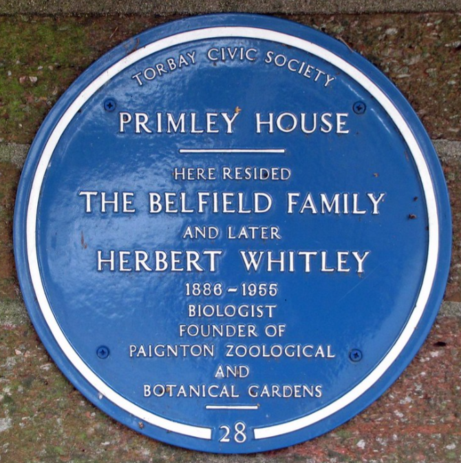 Blue plaque reading Torbay Civic Society, Primley House, here resided the Belfield family and later Herbert Whitley, 1886 to 1955, biologist, founder of Paignton Zoological and Botanical Gardens
