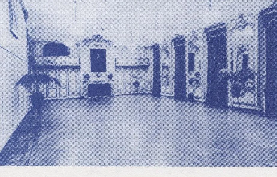 The ballroom at Oldway Mansion, with parquet floor, mirrors and a minstrels gallery above