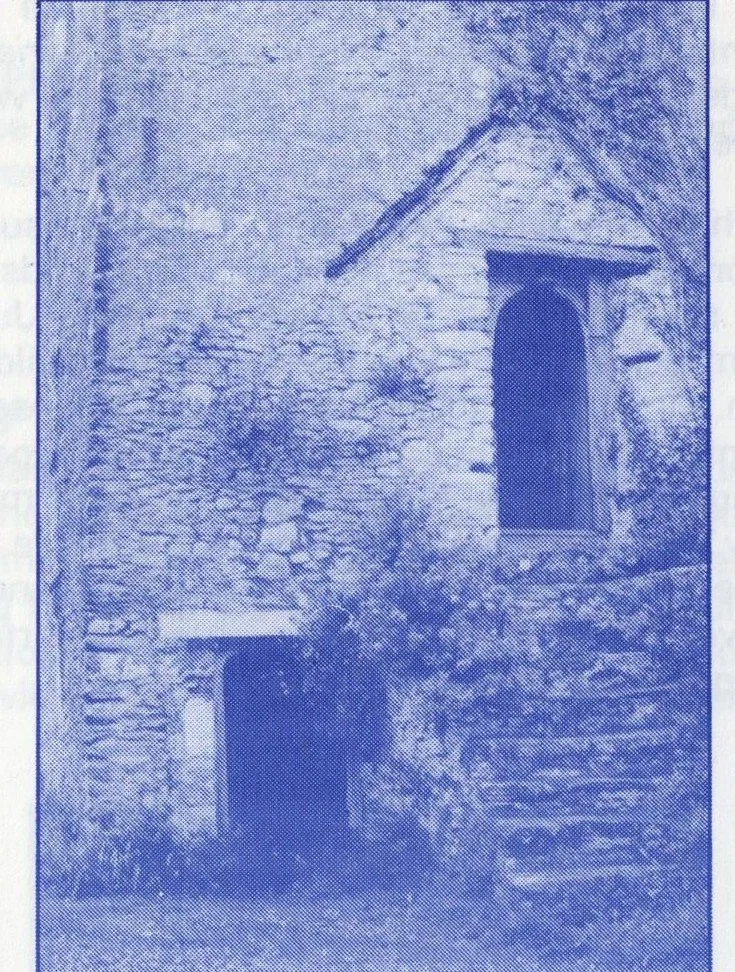 Photograph of Ilsham Chapel showing the arched chapel window and ground-floor doorway