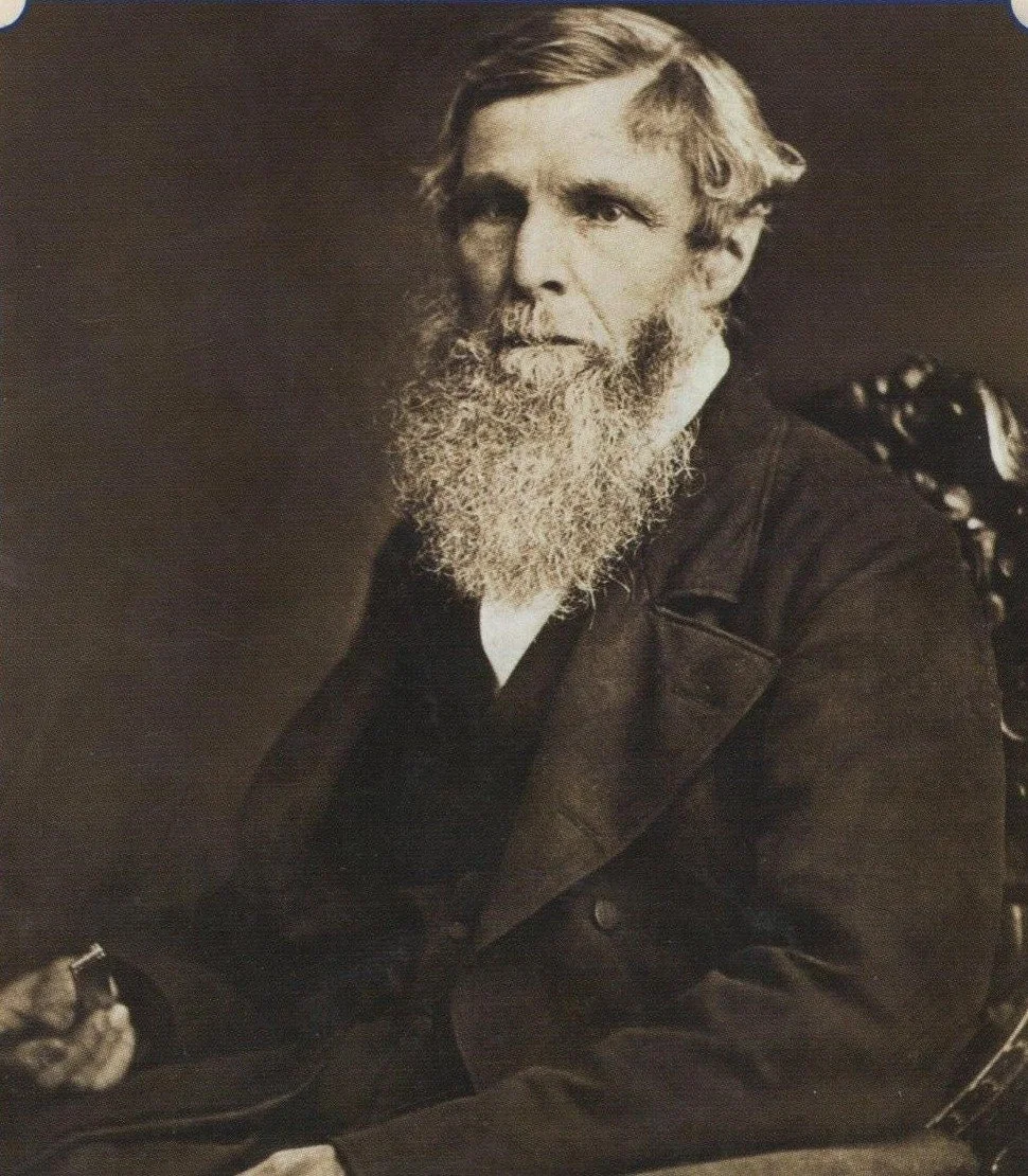 Photographic portrait of William Froude, a bearded Victorian gentleman seated in a chair