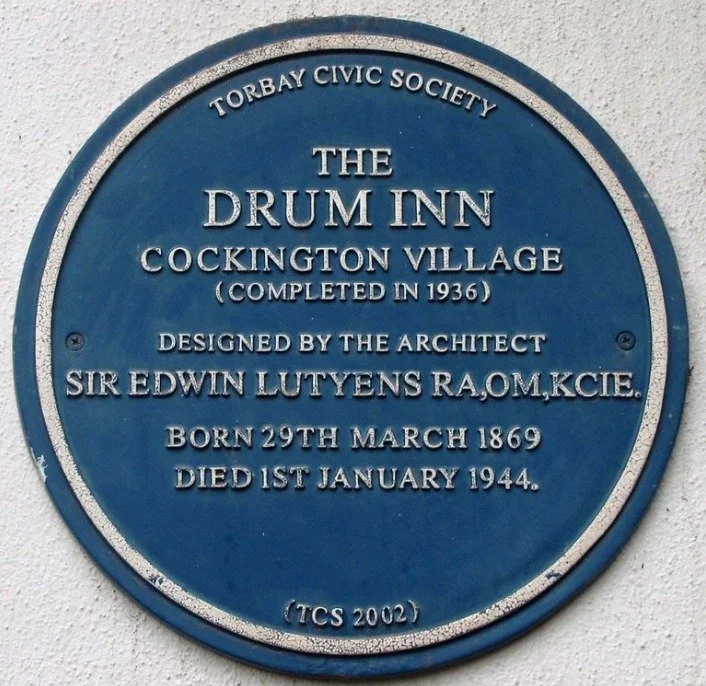 Blue plaque reading Torbay Civic Society, The Drum Inn, Cockington Village, completed in 1936, designed by the architect Sir Edwin Lutyens RA, OM, KCIE, born 29th March 1869, died 1st January 1944