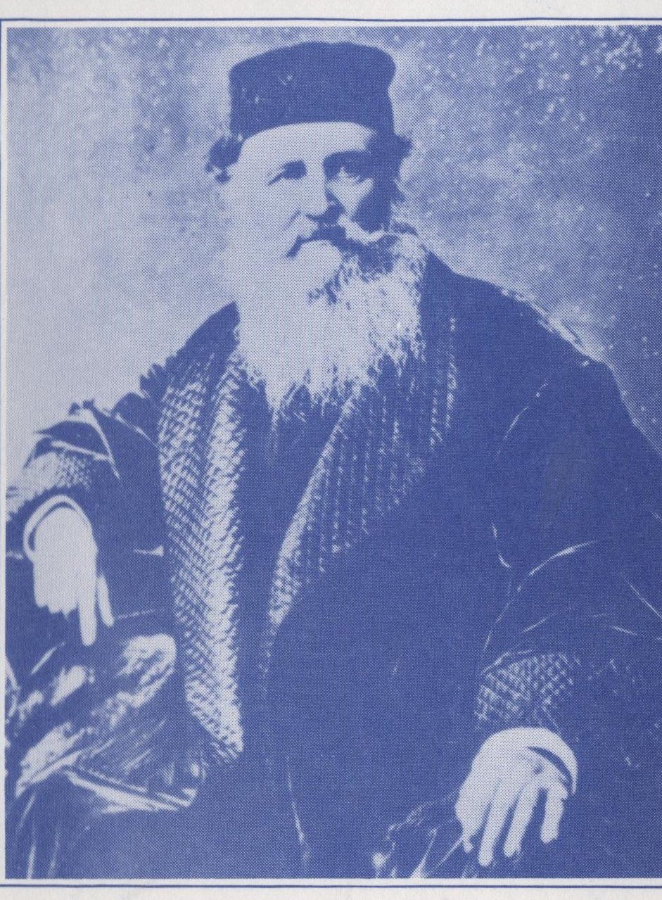 Studio portrait of Isaac Merritt Singer, seated, with a long beard and fur-trimmed coat