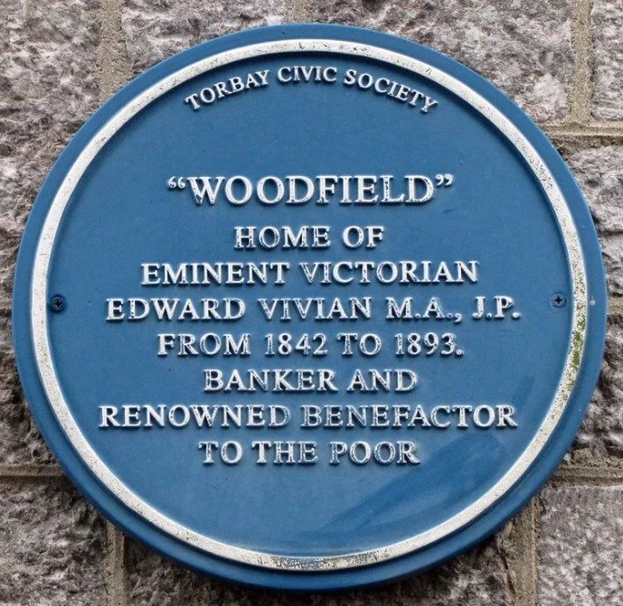 Blue plaque reading Woodfield, home of eminent Victorian Edward Vivian M.A., J.P. from 1842 to 1893, banker and renowned benefactor to the poor