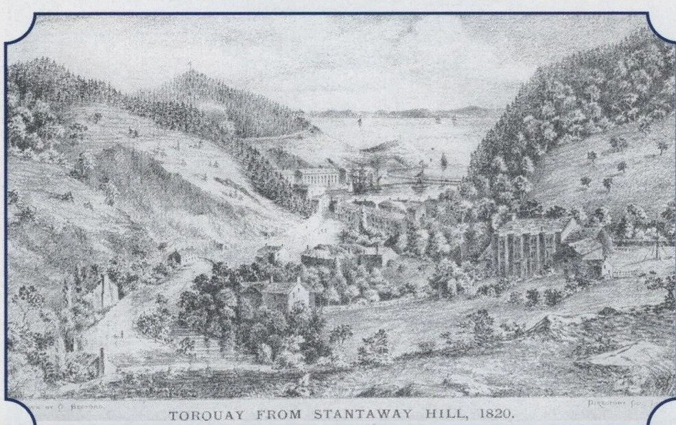 Engraving titled Torquay from Stantaway Hill, 1820, showing a wooded valley leading down to the harbour and town
