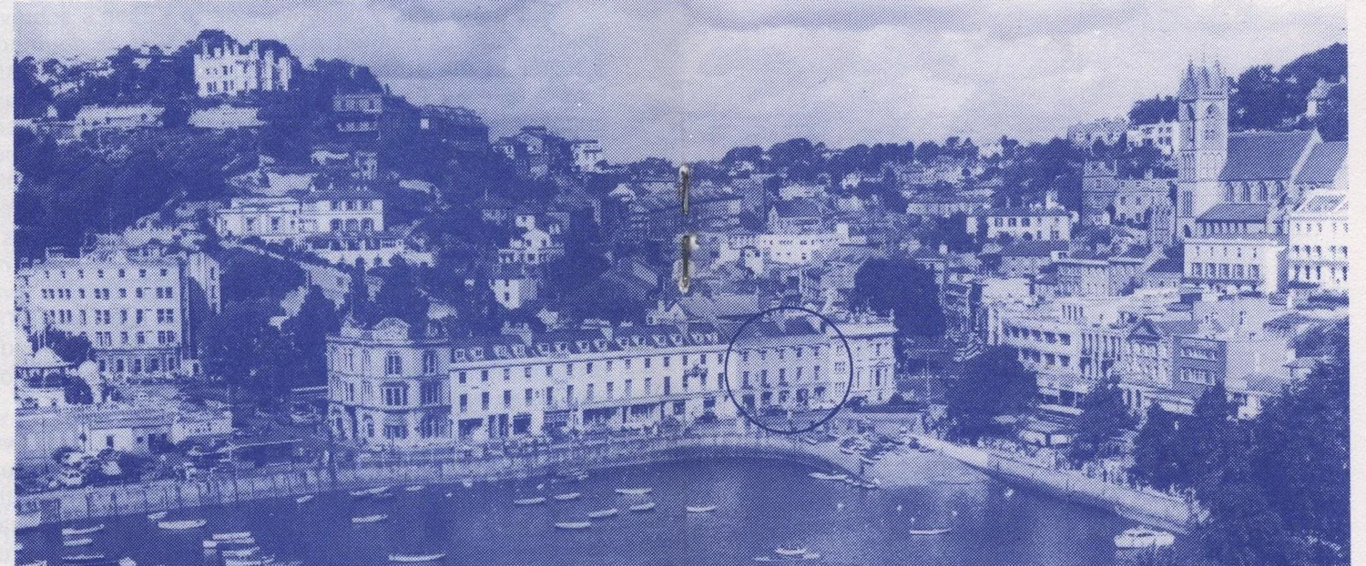 Aerial photograph of Torquay harbour and the town, with the Vaughan Parade offices marked by a circle