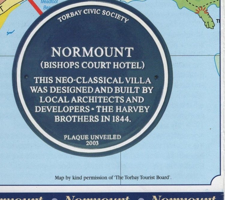 Blue plaque reading Torbay Civic Society, Normount, Bishops Court Hotel, this neo-classical villa was designed and built by local architects and developers, the Harvey Brothers, in 1844, plaque unveiled 2003