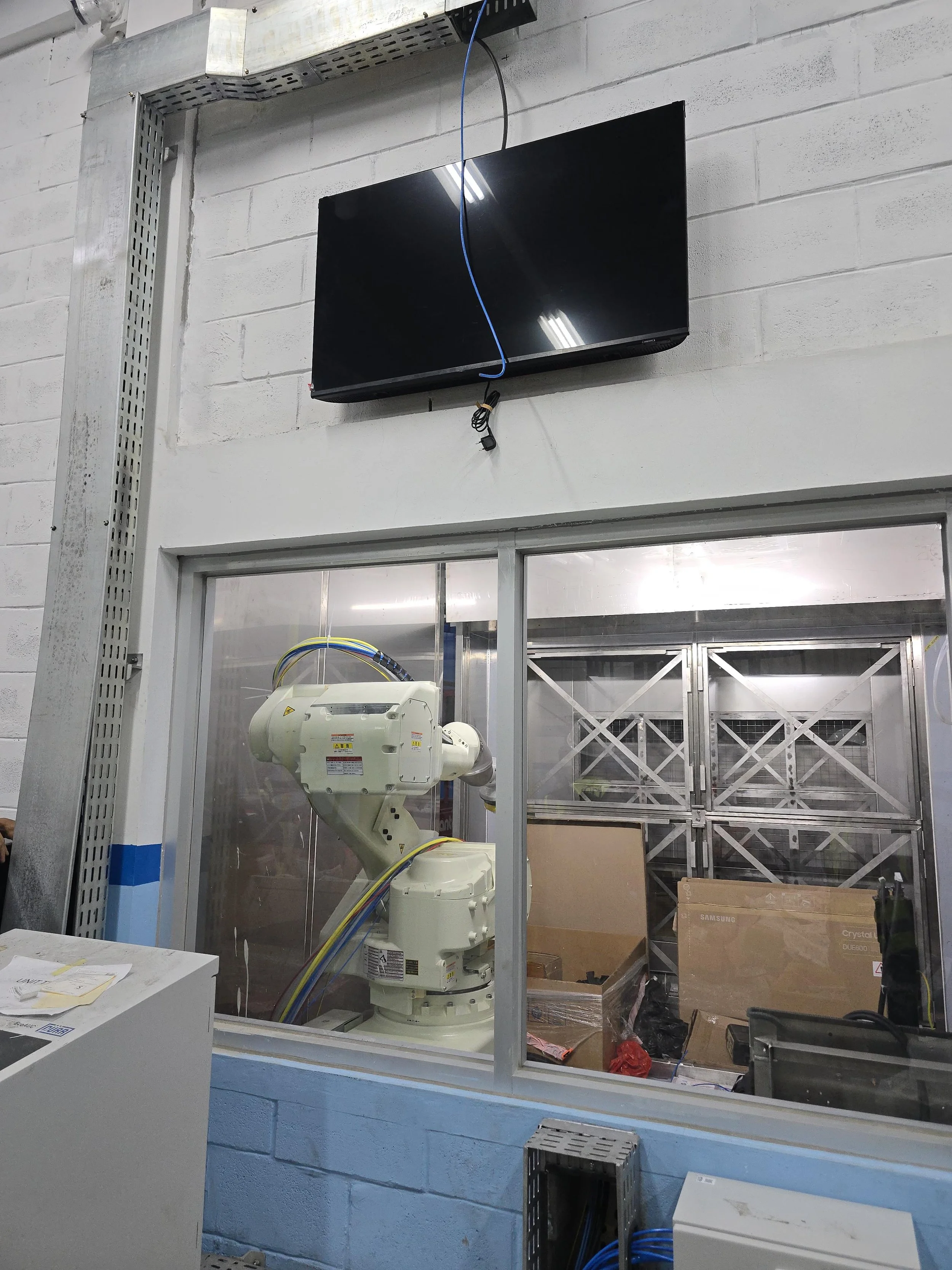 Painting robot inside the spray booth during system integration