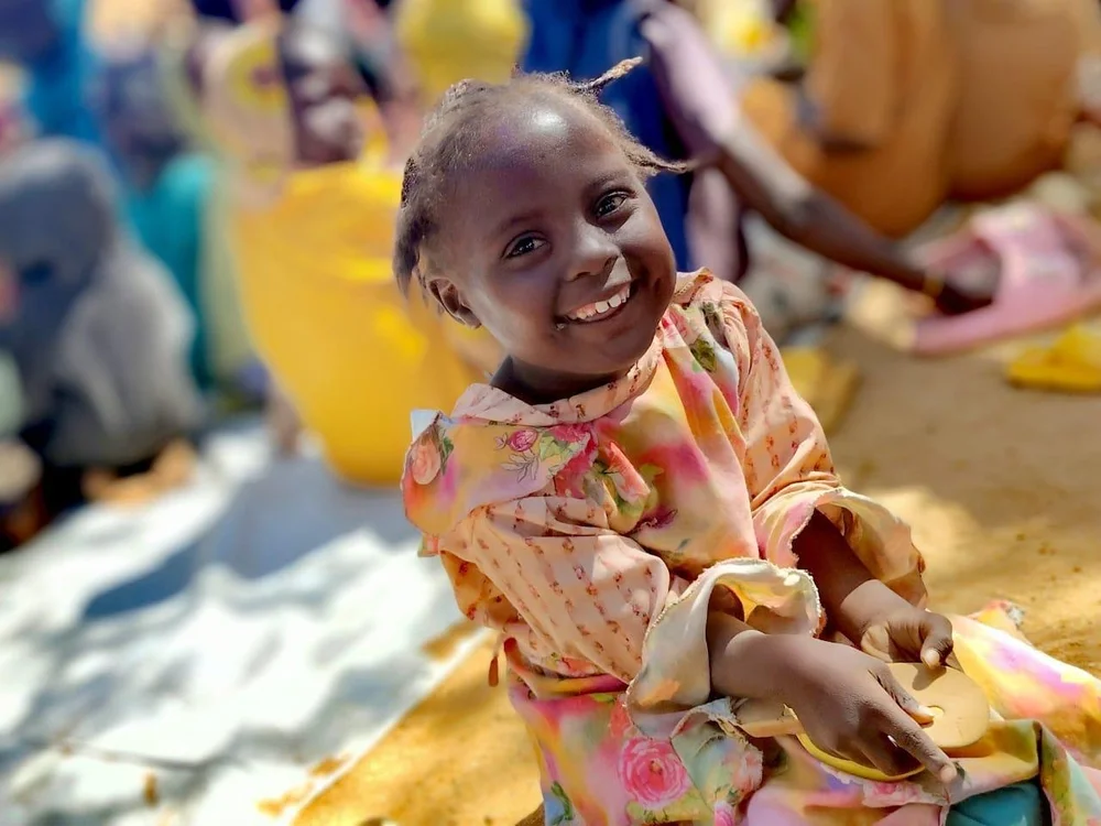A young child smiling during a shared play session