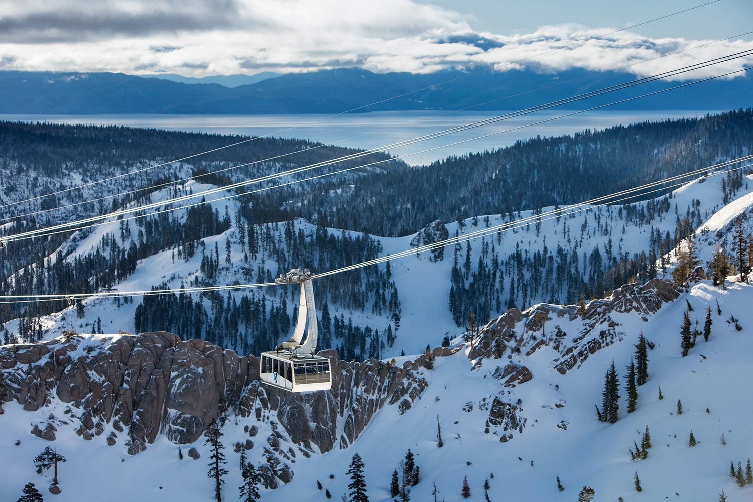 Aerial tram above Olympic Valley with Lake Tahoe beyond